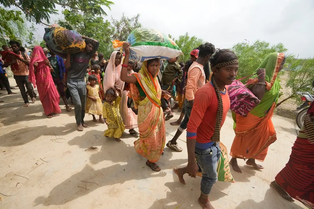 People evacuated from a village near Jakhau arrive at a shelter in Naliya, Kutch district | Photo: AP
