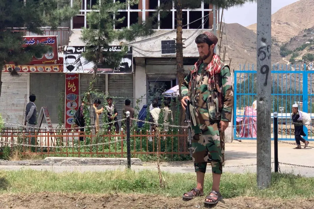 A member of Taliban stands guard near the site of a suicide attack in Badakhshan | Photo: AFP