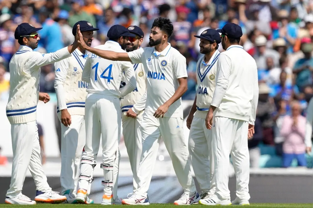 India's Mohammed Siraj, centre, celebrates after taking the wicket of Australia's Travis Head caught behind on the second day of the ICC World Test Championship Final between India and Australia | Photo: AP