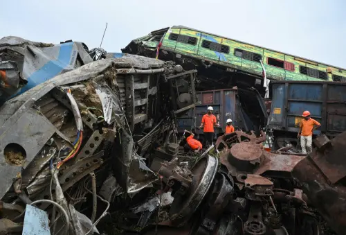 Rescue workers sift through wreckage at the accident site of a three-train collision near Balasore, about 200 km (125 miles) from the state capital Bhubaneswar in the eastern state of Odisha, on June 3, 2023. At least 288 people were killed and more than 850 injured in a horrific three-train collision in India, officials said on June 3, the country's deadliest rail accident in more than 20 years. (Photo by Dibyangshu SARKAR / AFP)