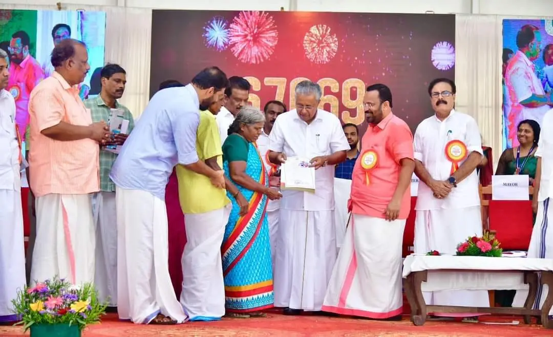 Chief Minister Pinarayi Vijayan distributing land title deeds to landless people in Thrissur | Photo: Facebook/XavierChittilappilly