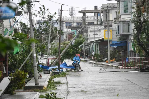 Local residents ride their motorbike amid a damaged street after Cyclone Mocha's crashed ashore, in Kyauktaw in Myanmar's Rakhine state on May 14, 2023. Cyclone Mocha crashed ashore in Myanmar and southeastern Bangladesh on May 14, 2023, uprooting trees, scattering flimsy homes in Rohingya displacement camps and bringing a storm surge into low-lying areas | Photo: AFP