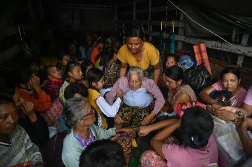People evacuate on a truck in Sittwe in Myanmar's Rakhine state on May 13, 2023, ahead of the landfall of Cyclone Mocha. Cyclone Mocha is expected to make landfall on May 14 between Cox's Bazar in Bangladesh, where nearly one million Rohingya refugees live in camps largely made up of flimsy shelters, and Sittwe on Myanmar's western Rakhine coast | Photo: AFP