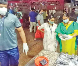 Officials inspecting fish