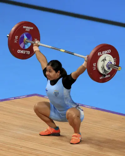 India's Bindyarani Devi Sorokhaibam in action during the Women's 55kg weightlifting event at The NEC on day two of the Commonwealth Games in Birmingham, England, Saturday July 30, 2022 | Photo: AP