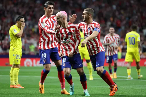 Antoine Griezmann (C) celebrates scoring the opening goal | AFP
