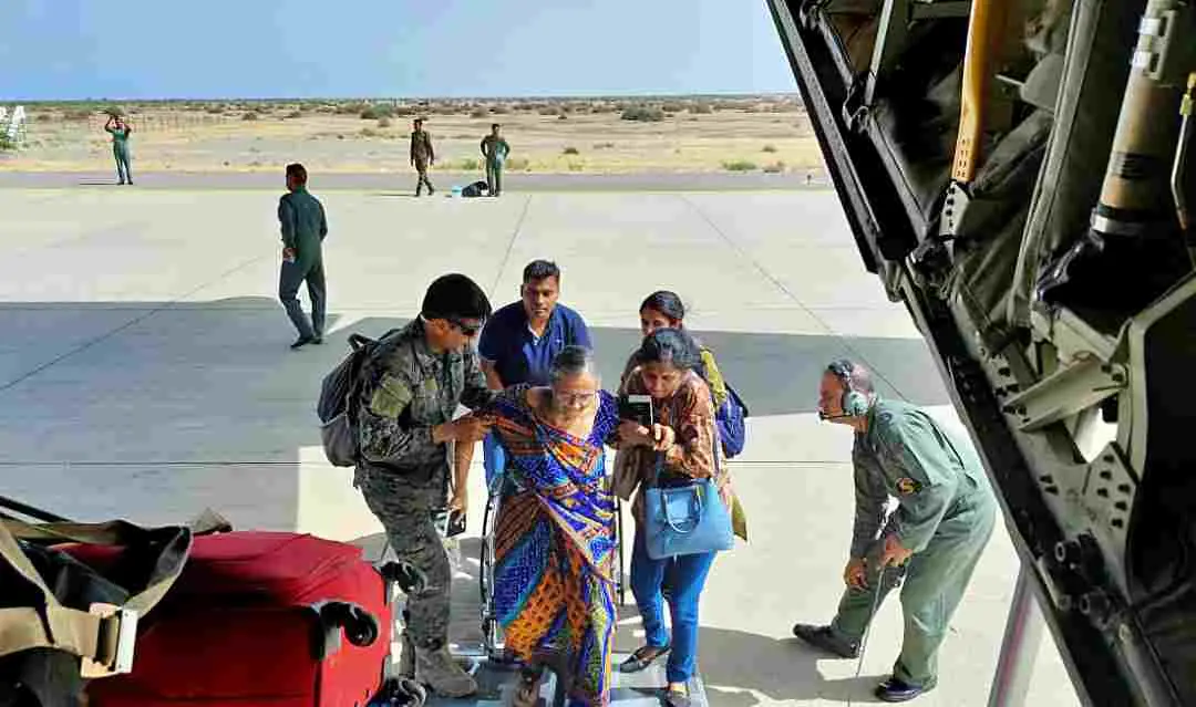 An elderly stranded Indian national being assisted in boarding the IAF C-130J flight as she leaves for Jeddah from Port Sudan | Photo: ANI