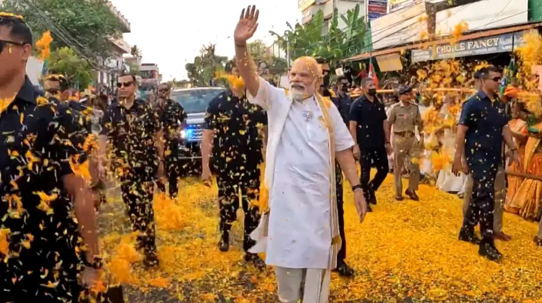 Prime Minister Narendra Modi waves at supporters during a roadshow in Kochi | Photo: PTI