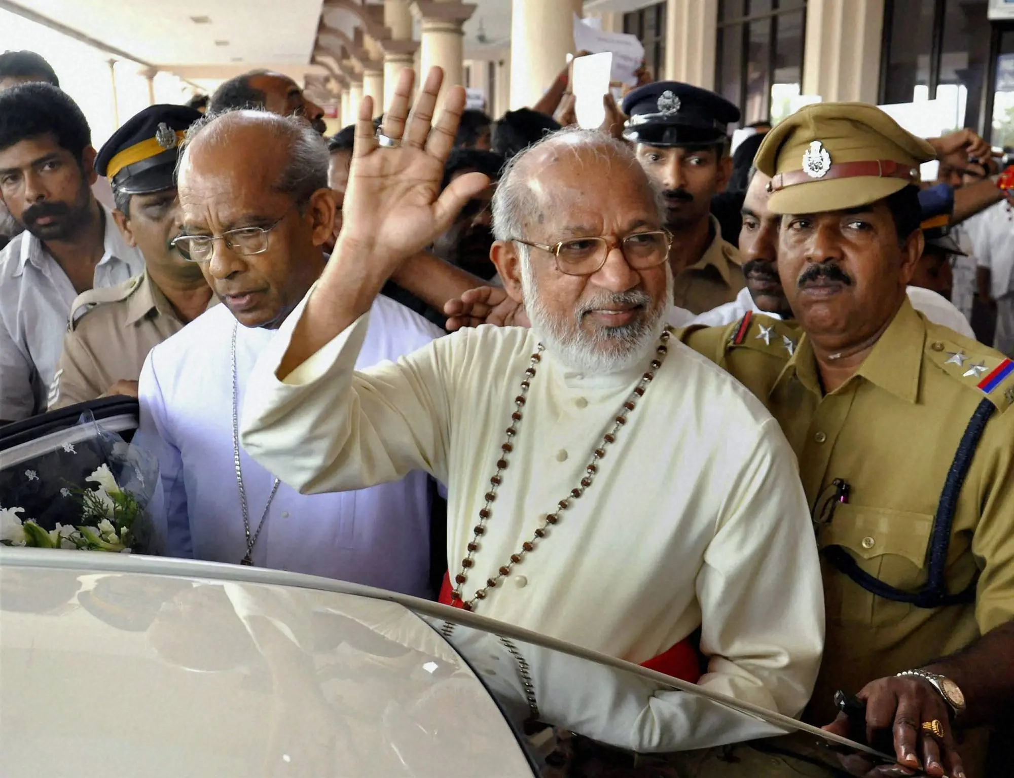 Cardinal Mar George Alencherry waves to his followers on his arrival at the airport in Kochi on Saturday two weeks after his elevation to the College of Cardinals by Pope Benedict XVI | Photo: PTI Photo