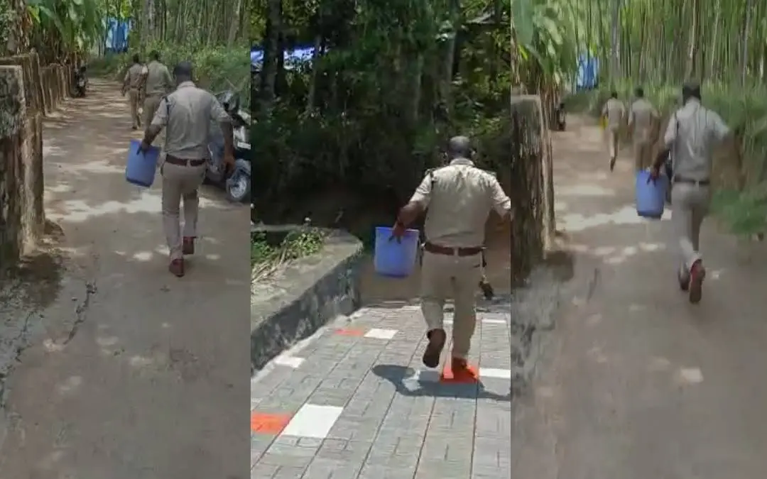 ബക്കറ്റില്‍ കണ്ടെത്തിയ കുഞ്ഞുമായി പോലീസുകാര്‍ വാഹനത്തിലേക്ക് ഓടുന്നു