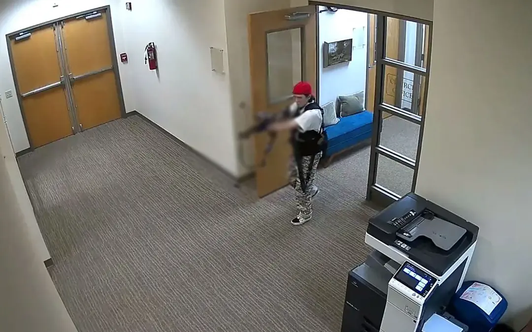 This handout video grab image released on March 27, 2023, shows suspect Audrey Hale holding an assault rifle at the Covenant School building at the Covenant Presbyterian Church, in Nashville, Tennessee | Photo: Metropolitan Nashville Police Department / AFP