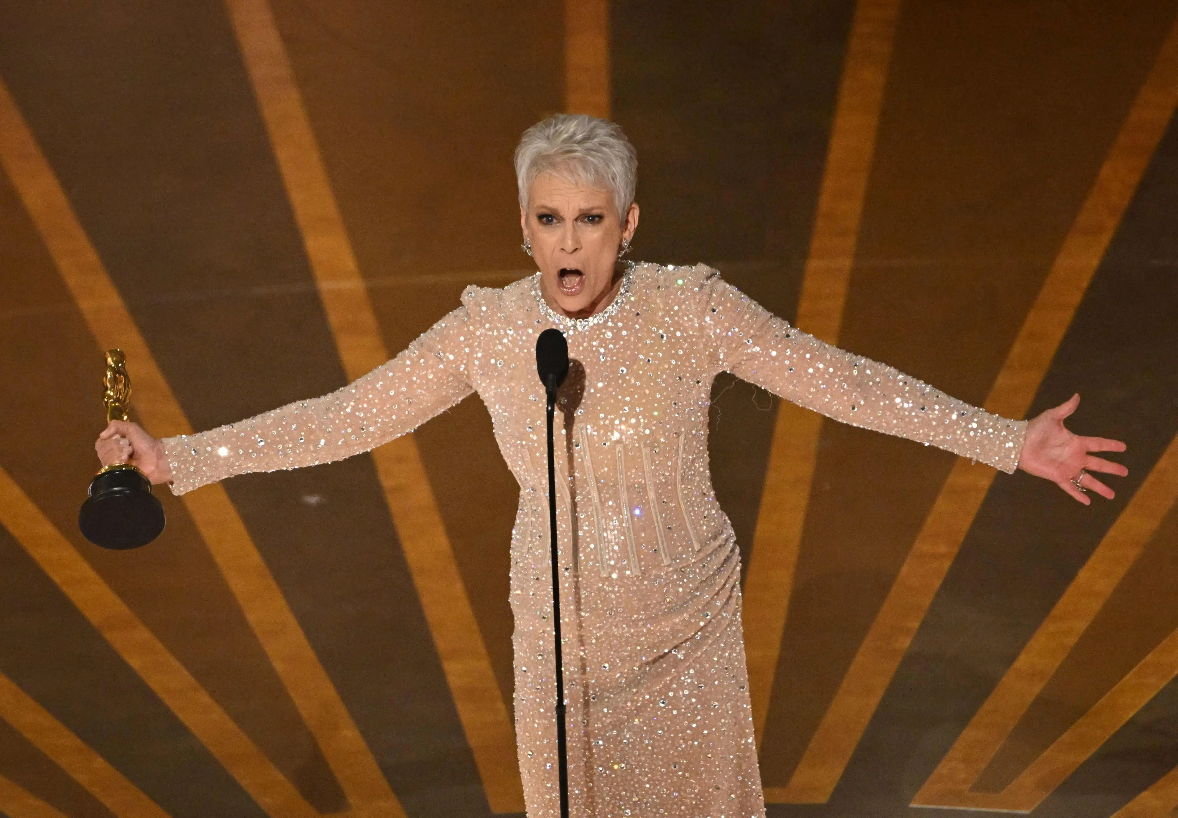 US actress Jamie Lee Curtis accepts the Oscar for Best Actress in a Supporting Role for 'Everything Everywhere All at Once' onstage during the 95th Annual Academy Awards at the Dolby Theatre in Hollywood | Photo: AFP