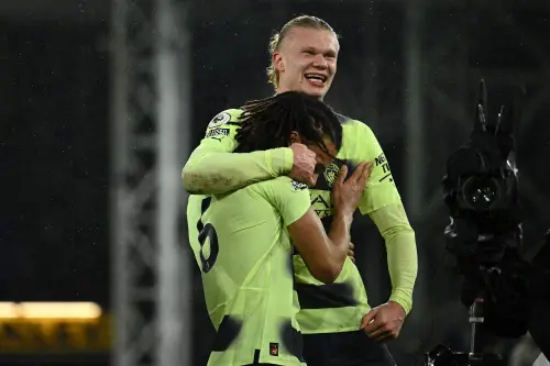 Erling Haaland (R) celebrates with Manchester City's Dutch defender Nathan Ake(L) | AFP