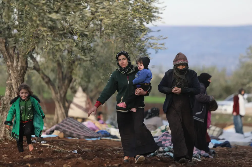 Syrians, displaced as a result of the deadly earthquake that hit Turkey and Syria two days ago, take shelter on the outskirts of the rebel-held town of Jindayris | AFP