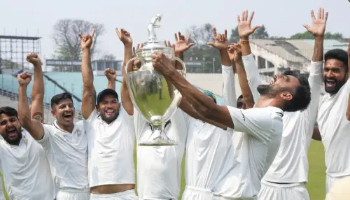 Saurashtra's captain Jaydev Unadkat with teammates celebrates with the trophy | PTI