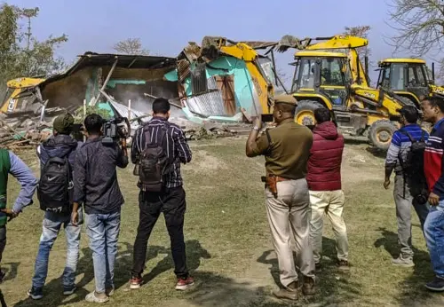 Police and media personnel near a site where an eviction drive being carried out by District Administration, at Burachapori Wildlife Sanctuary in Sonitpur, Tuesday, Feb. 14, 2023 | Photo: PTI