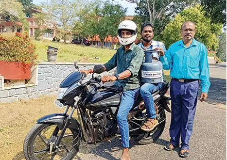 Dr CA Jayaprakash near bike running on natural gas produced from tapioca leaves