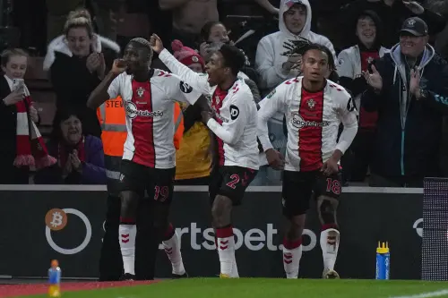 Moussa Djenepo, left, celebrates with teammates after scoring | AP