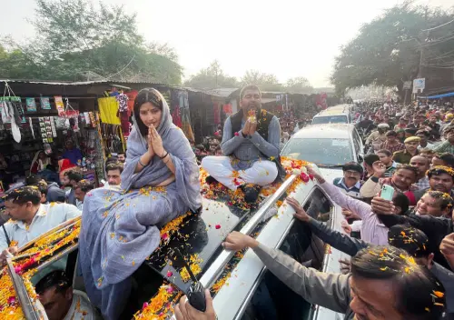 Samajwadi Party (SP) chief Dimple Yadav greets the supporters during a roadshow for the Mainpuri by-elections, at Jaswantnagar, in Etawah on Saturday | ANI Photo