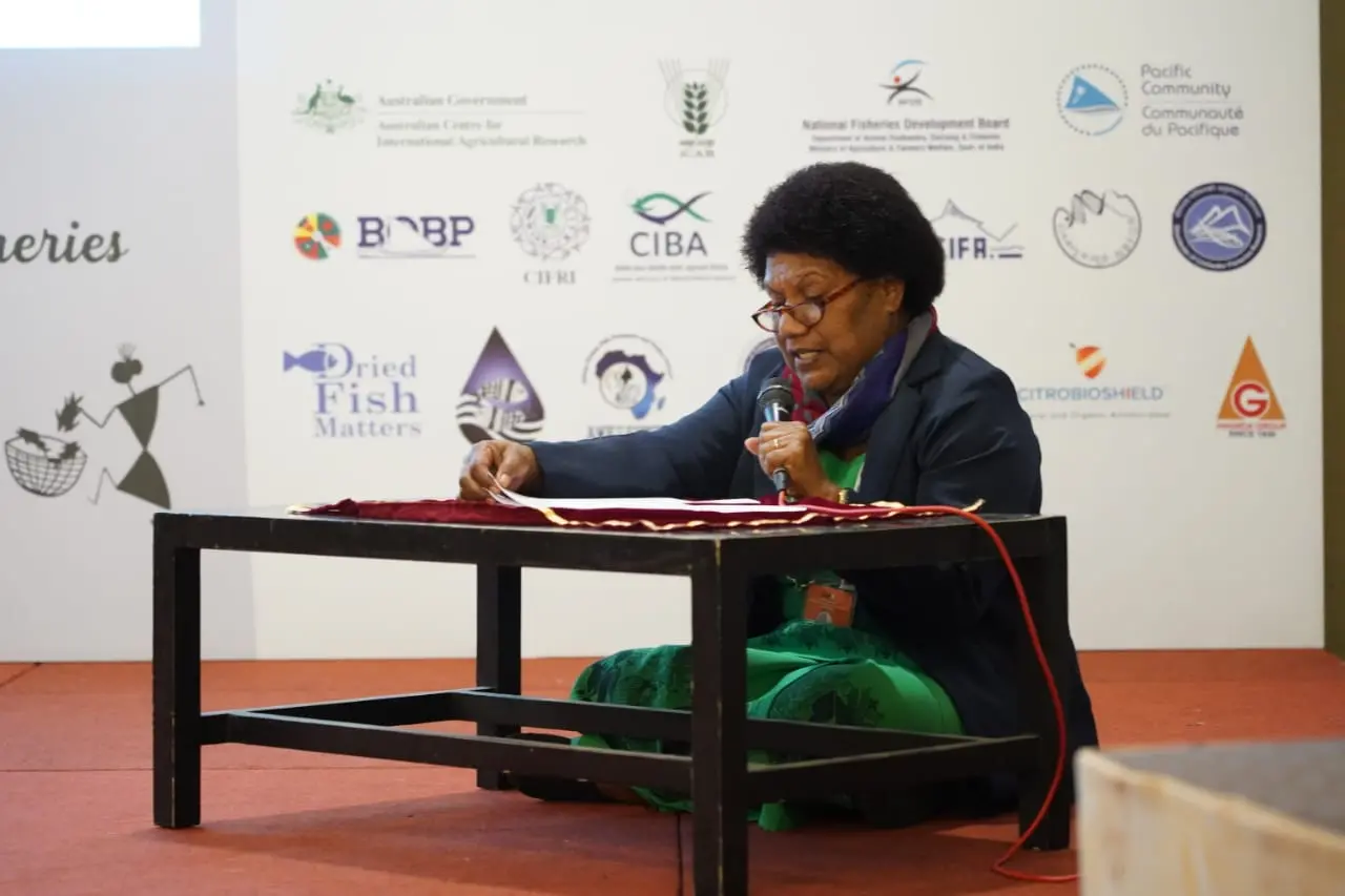 Tarusila shares her experiences at GAF8 while seated in the conference room during an interactive session