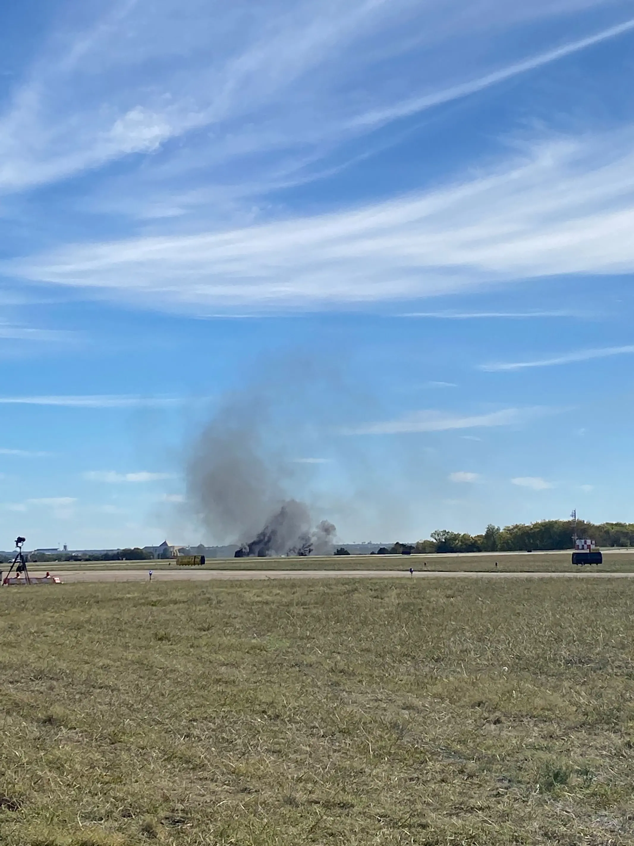 Smoke rising from the crash after two planes collided mid-air during the Wings Over Dallas Airshow at Dallas Executive Airport. Photo: AFP