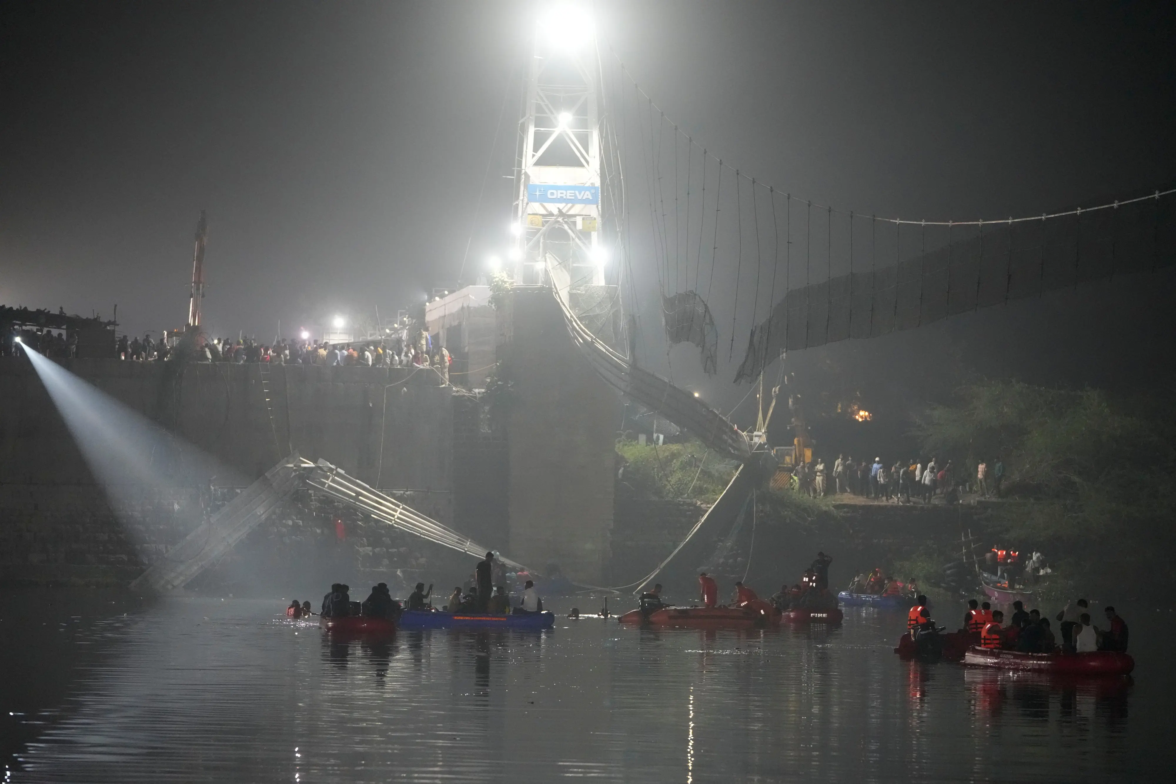 Rescuers on boats search in the Machchu river next to a cable suspension bridge that collapsed in Morbi. Photo: AP