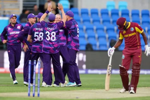 Michael Leask (C) celebrates with teammates after dismissing West Indies' captain Nicholas Pooran I AFP