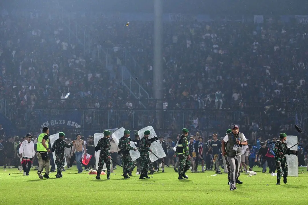 Indonesian army securing the pitch following the stampede. Photo: AFP