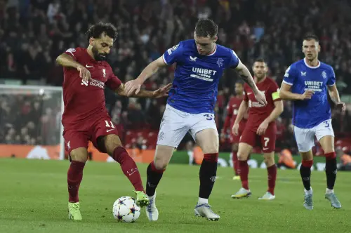 Mohamed Salah, left, and Rangers' Leon King challenge for the ball | AP