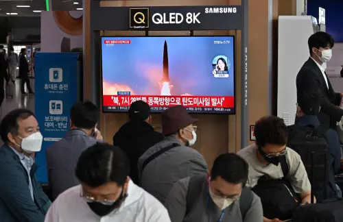 A news broadcast with file footage of a North Korean missile test | AFP