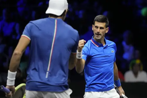 Novak Djokovic, right, celebrates with Matteo Berrettini after winning a point | AP