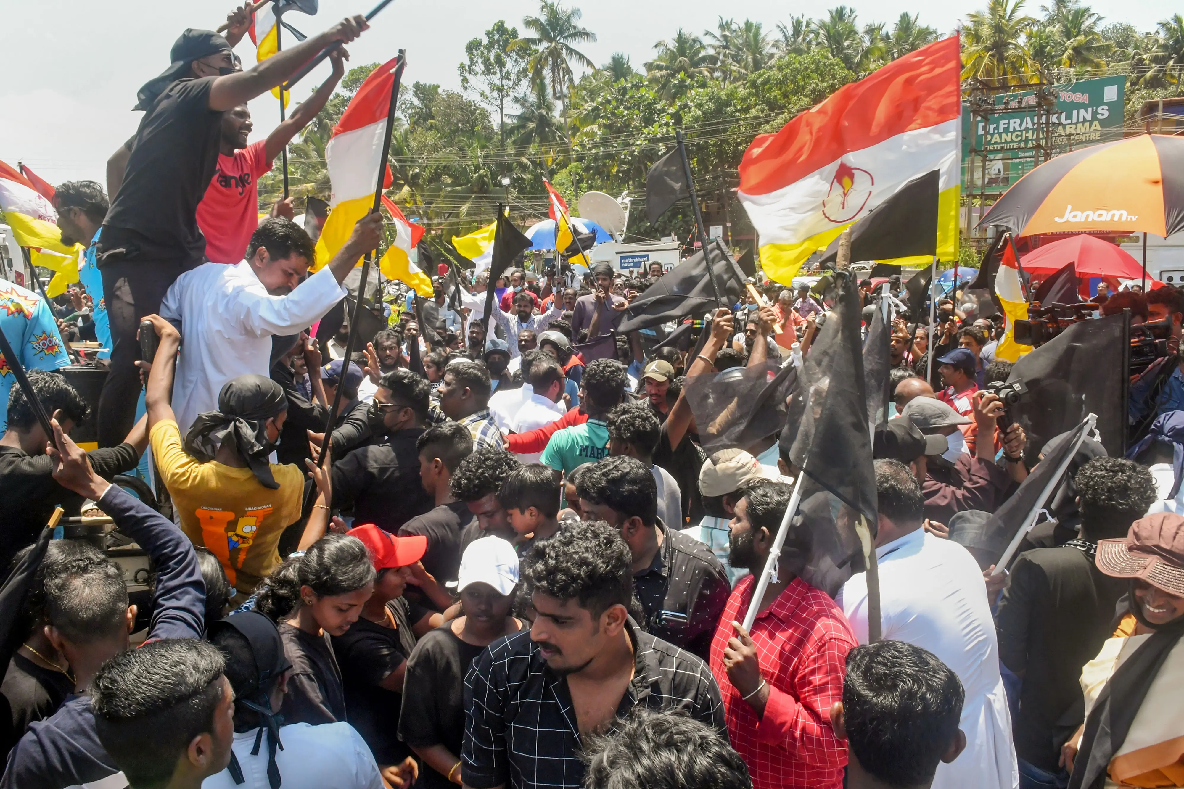 Fisherfolk and locals holding black flags stage a protest against Adani Groups' port development project at Vizhinjam, outside the main entrance of Adani Port in Thiruvananthapuram, Tuesday, Aug. 16, 2022. (PTI Photo)
