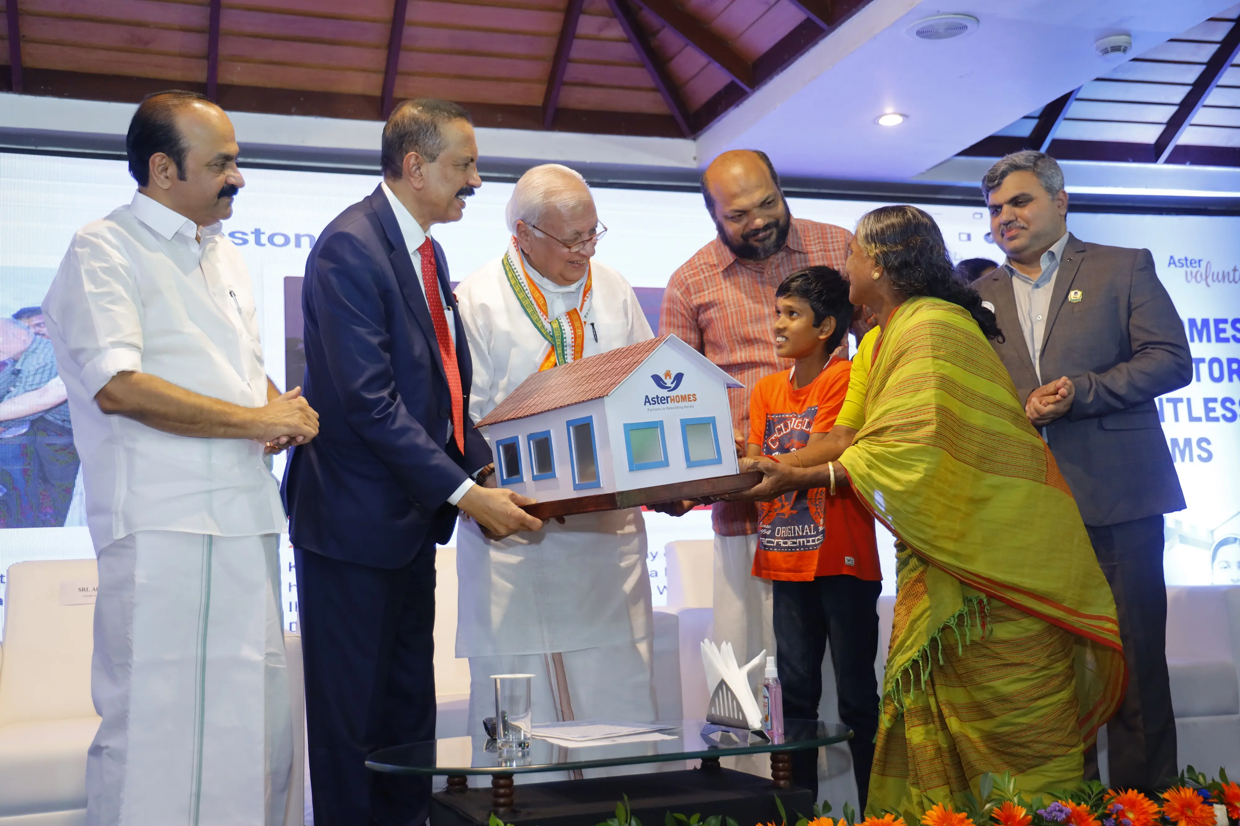 Kerala Governor Mohammad Arif Khan handing over keys of 255 houses built by Aster DM Healthcare's social service arm 'Aster Volunteers' in association with Rebuild Kerala project