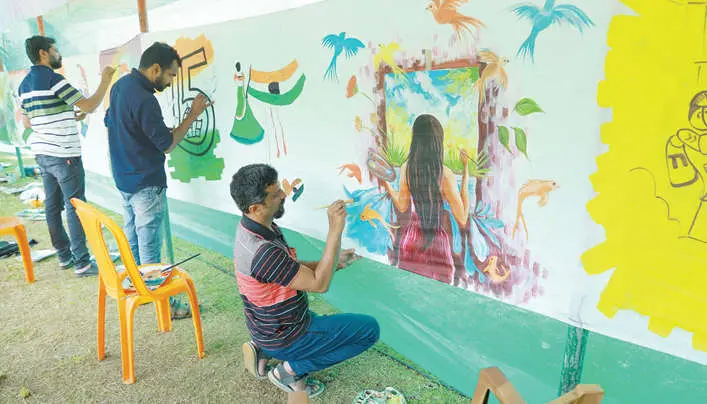The artists painting on the canvas