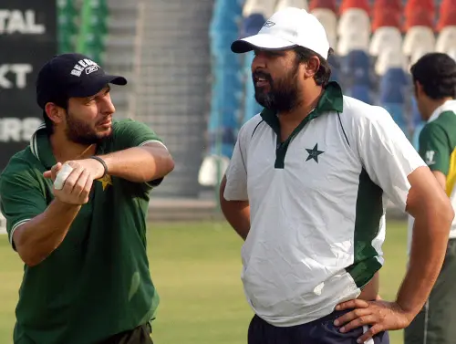 Shahid Afridi, left, talks with skipper Inzamam ul Haq |AP File