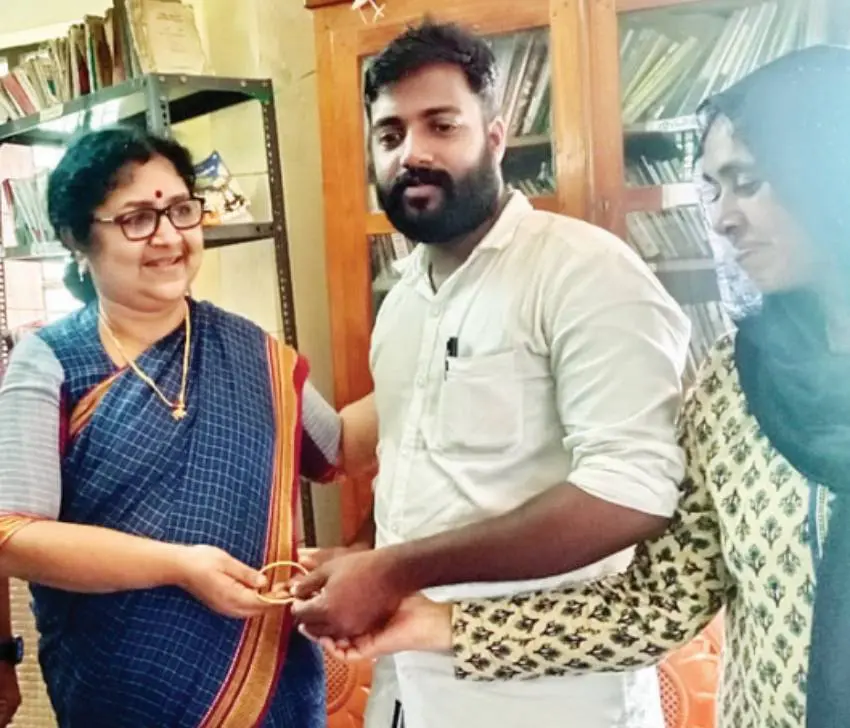 Minister R Bindu hands over gold bangle to PK Manu Mohan and Naseema Kunjumon
