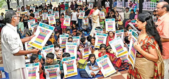 Pamphlets with Malayalam alphabets distributed among children