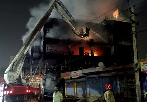 Fire officials try to douse a fire in a four storied building, in New Delhi, India, Friday, May 13, 2022 | Photo: AP