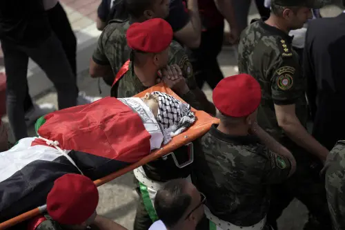 Slain Al Jazeera veteran journalist Shireen Abu Akleh is carried by a Palestinian honor guard in the West Bank city of Nablus, Wednesday, May 11, 2022. She was shot and killed while covering an Israeli raid in the occupied West Bank town of Jenin early Wednesday | Photo: AP