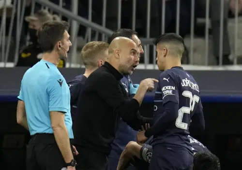Pep Guardiola, center, gives instructions to Manchester City's Joao Cancelo | AFP