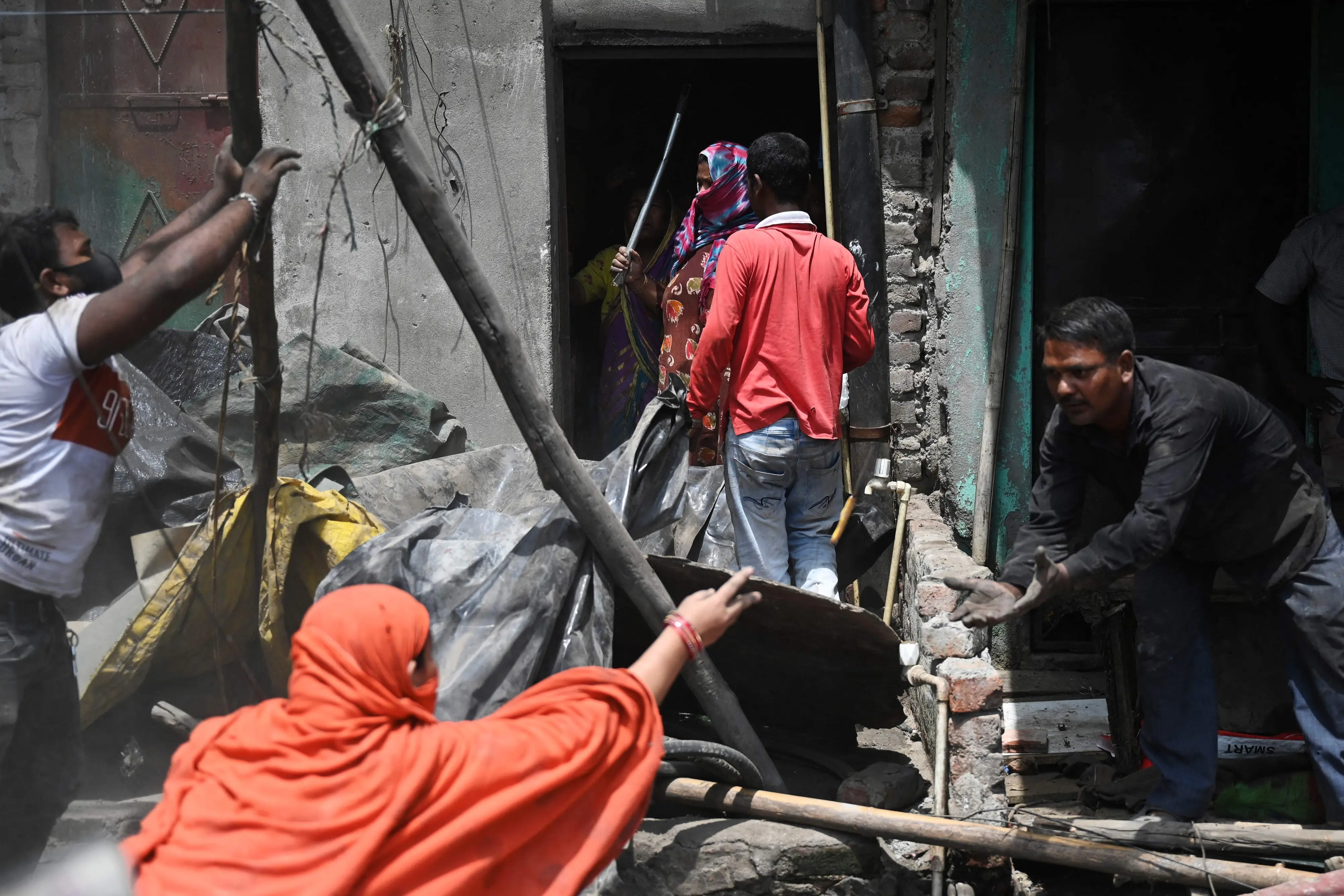 Residents search for their belongings after illegal structures were demolished in a residential area of Jahangirpuri | Photo: AFP