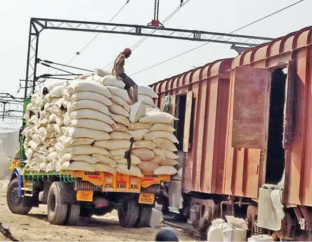 Sacks being unloaded from goods train onto a lorry at Chalakudy railway station