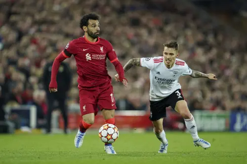 Mohamed Salah, left, competes for the ball with Benfica's Alex Grimaldo | AP