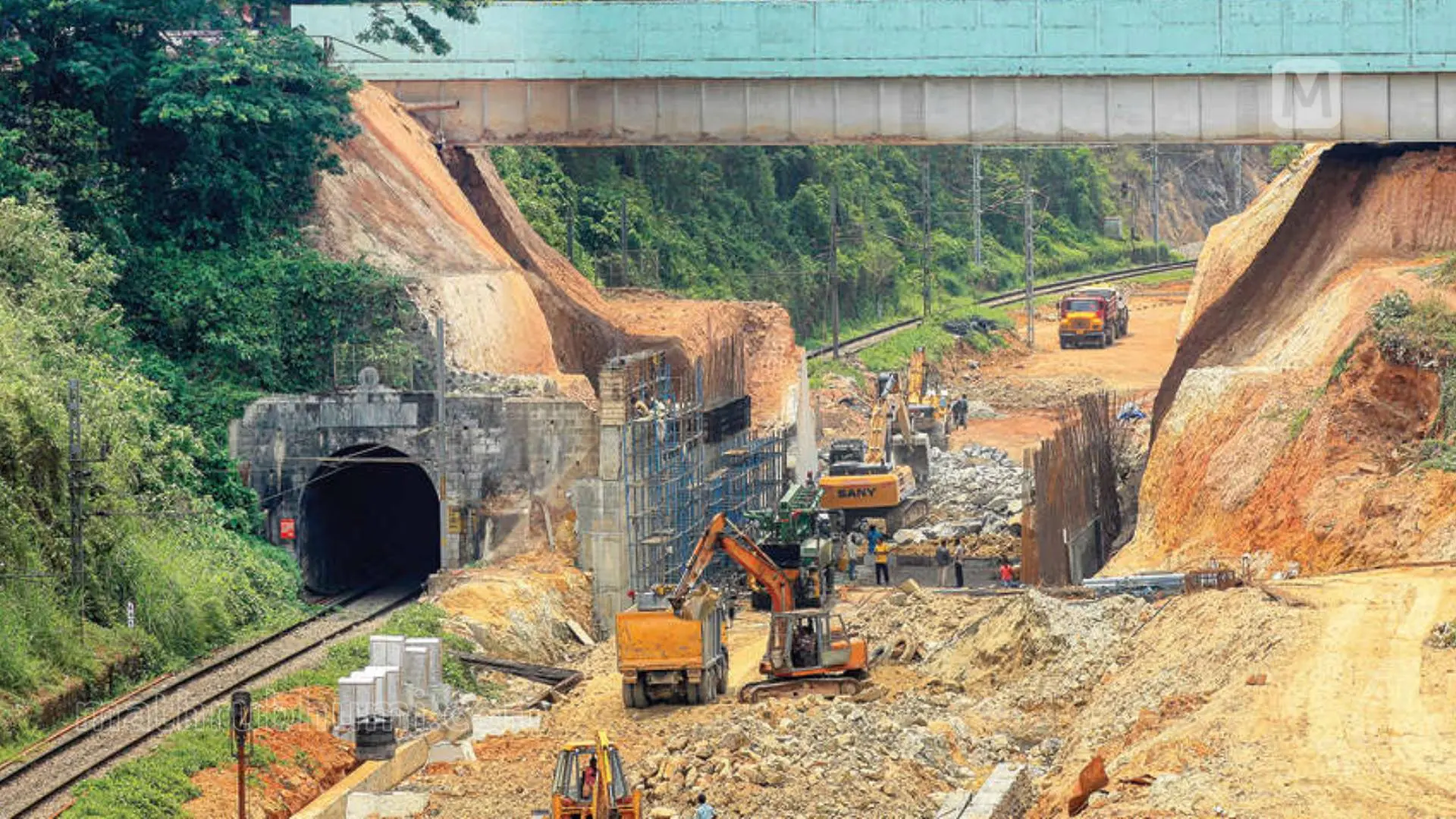 Building of safety walls and removal of sand to make space for tracks near the tunnel