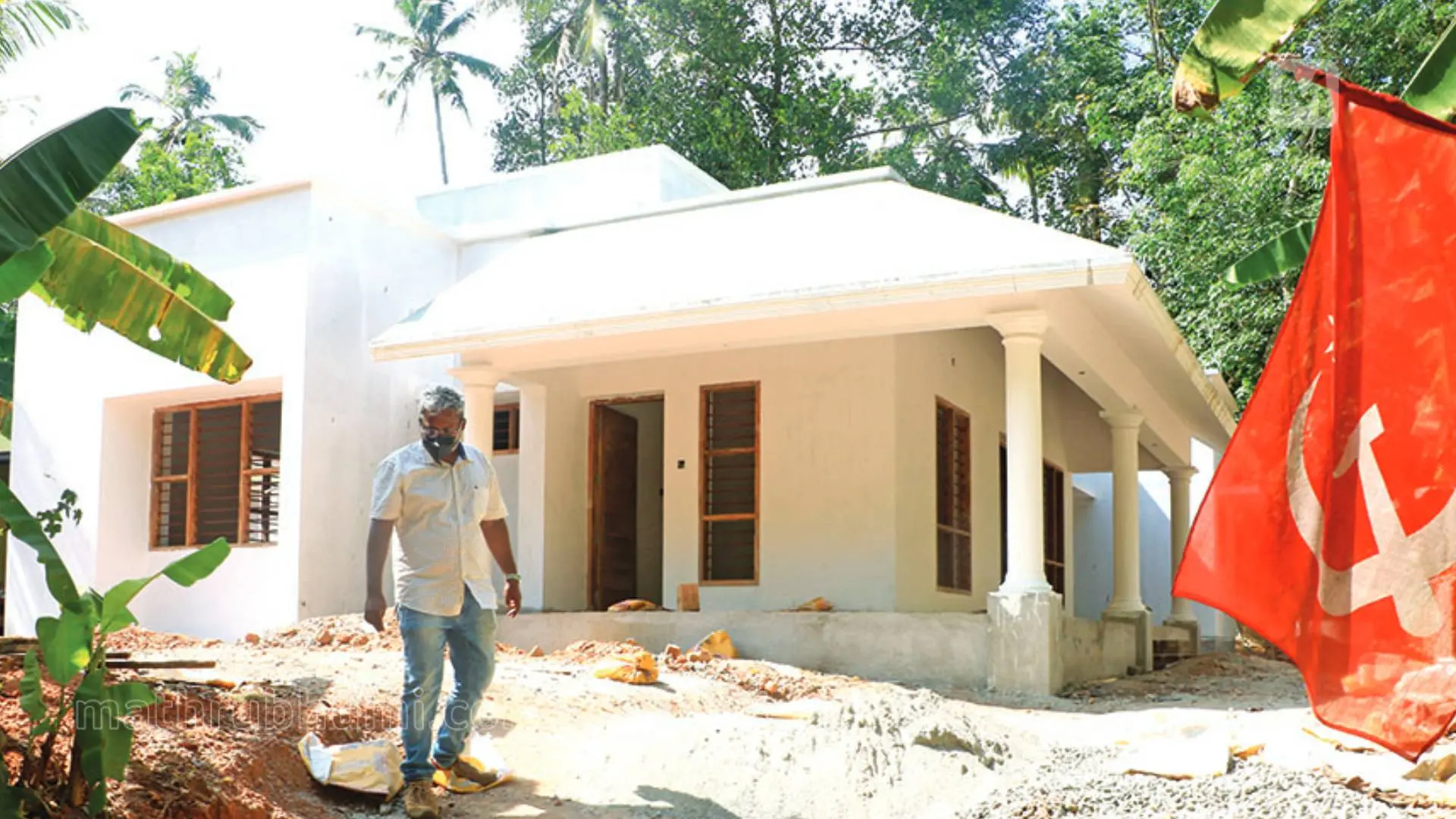 PK Gurudasan in front of his newly built house