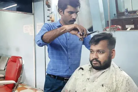 Assistant professor turns barber in evening