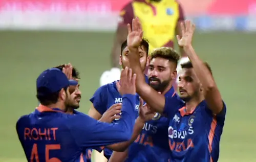 Harshal Patel celebrates after dismissing West Indies batter Romario Shepherd I PTI