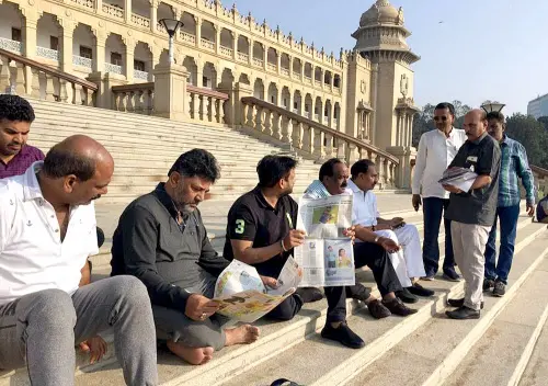 Congress MLAs, including DK Shivakumar, sit outside the Vidhana Soudha as part of an overnight protest demanding the State Minister KS Eshwarappa's resignation over his alleged remark on the National flag, in Bengaluru on Friday. (ANI Photo)