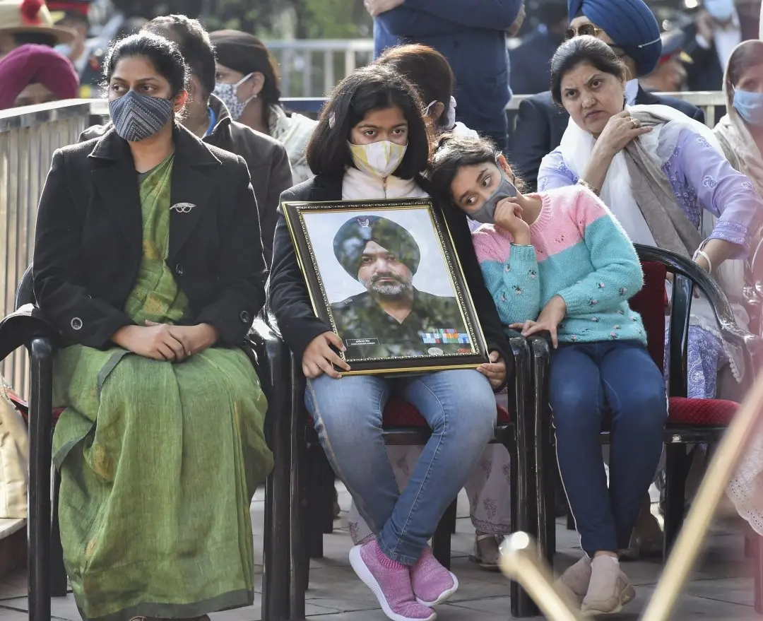 Wife Prafulla Menezes and daughters of Lt Colonel Harjinder Singh, who died in the Tamil Nadu chopper crash, during his last rites at Brar Square in New Delhi. Photo: PTI