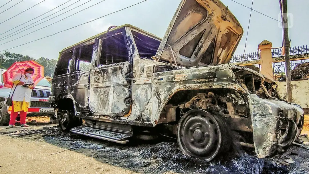 Forensic team examining the police jeep set ablaze by the migrant labourers